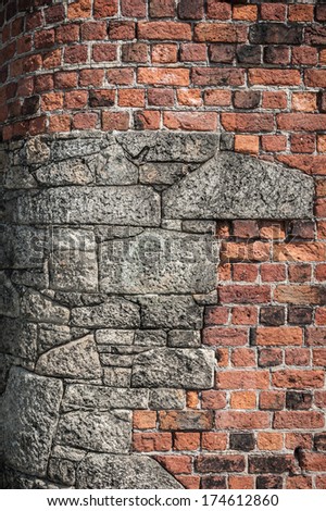 Corner stones at Liverpool dock set in old red brick surrounding wall for strength.