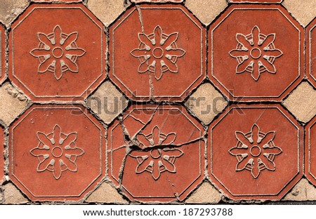 Old Victorian hexagonal floral pattern floor tiles showing wear.