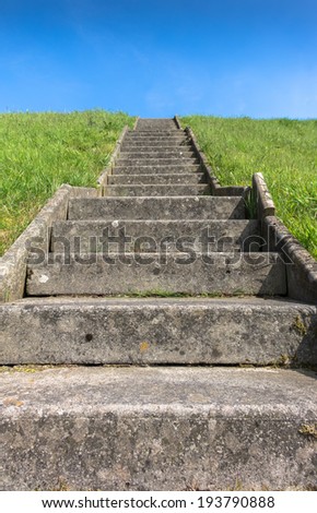 Old concrete steps leading to the top of a hill.