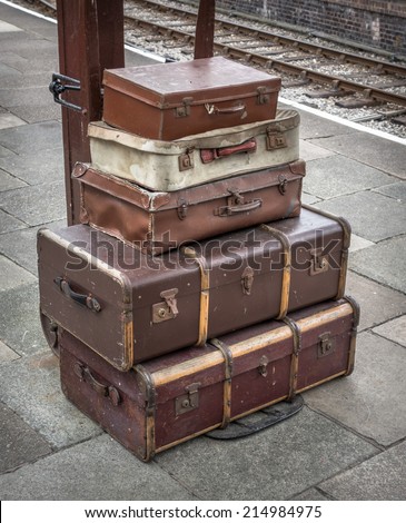Vintage travel cases at a railway station.