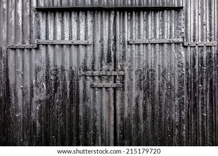 A corrugated tar black industrial door background.
