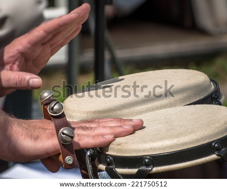 Percussionist playing with sleigh bells and bongos.