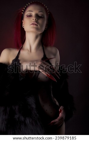 Beautiful woman with red hair and long nails