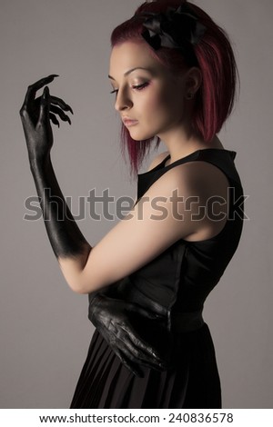 Beautiful elegant woman with red hair and black hands