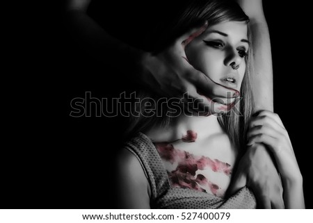 Abused young female. Violence against women, rape concept. Stop hurting woman. Men\'s hands holding girl, toutching face and chest, blood