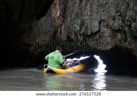 PHANG NGA BAY, THAILAND - 27 May 2012 : An unidentified man paddle canoeing through the cave(Tham Lod) at Phang-nga, Thailand.