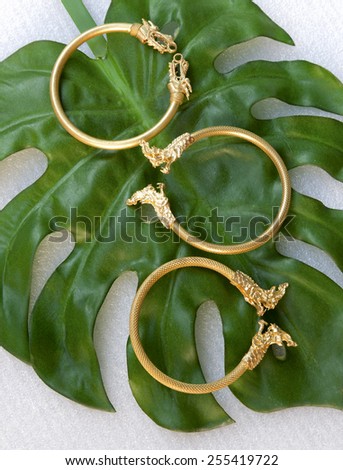 Thai gold bracelet dragon design on green leaf