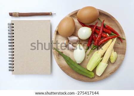 Vegetarian concept with blank notebook on white background