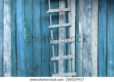 Blue retro tone hardwood handmade ladder with old wood wall background