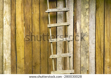 Yellow retro tone Hardwood handmade ladder with old wood wall background