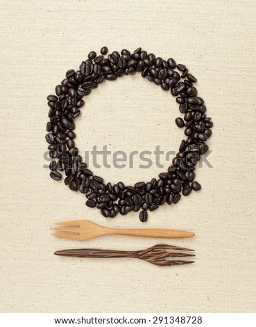 Coffee bean round frame with wooden fork background