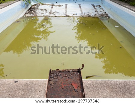 Dirty swimming pool water in old swimming pool