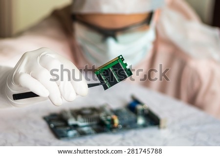 Young scientist repairs electronic circuit and holding damaged electrical component