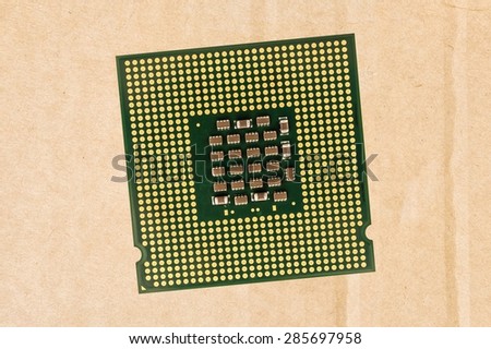 Computer processor chip (CPU) isolated on carton background