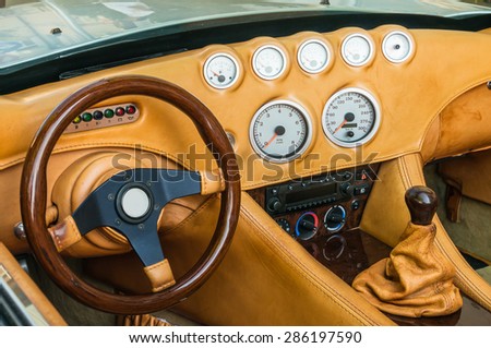 Steering wheel, shift lever and dashboard inside the luxury car