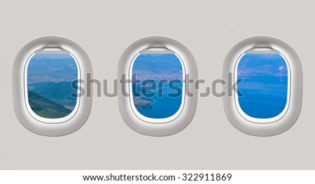 Looking out the windows of a plane to the sea bay, view from above