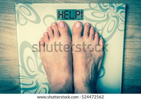 Woman\'s feet on a scale with word HELP! - obesity concept - retro style