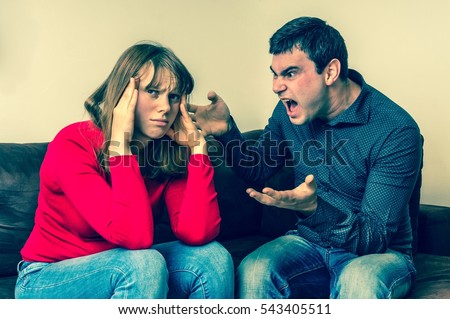 Unhappy couple having argument at home - conflict and family concept - retro style