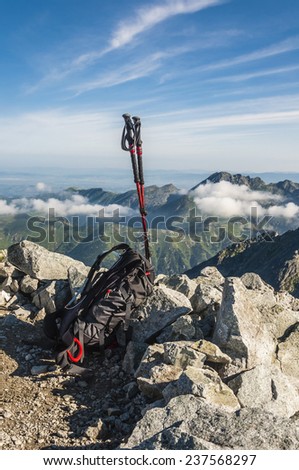 Black and red hiking poles and a backpack
