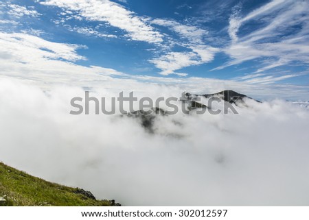 Peaks forming a kind of island in a sea of clouds