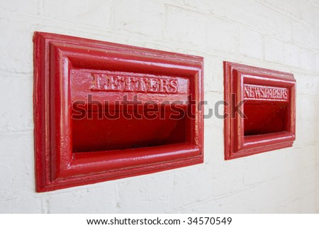Red letterbox and Newspaper box in old style inset into brick wall