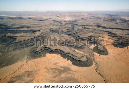 The landscape from an airplane at the South African desert. Beautiful reliefs Savannah-like picture under the microscope.
