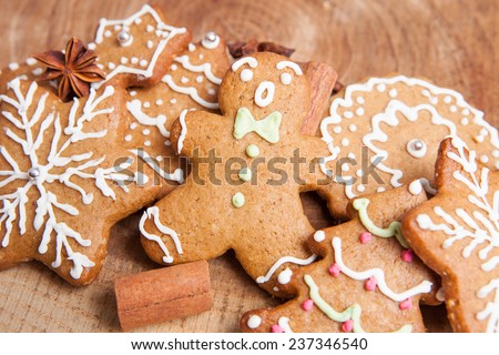 Gingerbread man with gingerbread cookies with cinnamon on a wooden background