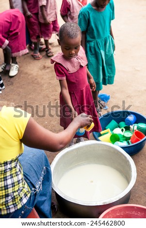TANZANIA, AFRICA - AUGUST 2014: Children at the kindergarten eating the semolina soup, from the village of Morogoro.
