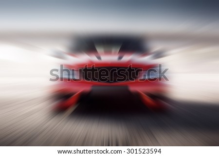 Red sport car fast speed drive motion blur background