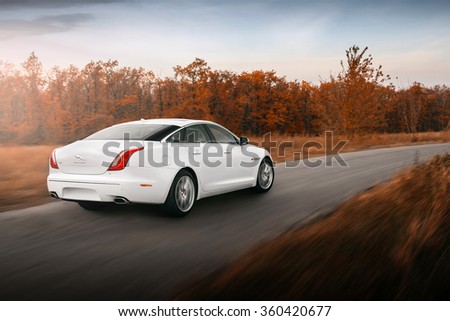 Saratov, Russia - October 16, 2014: Car Jaguar XJ drive speed on asphalt road at sunset