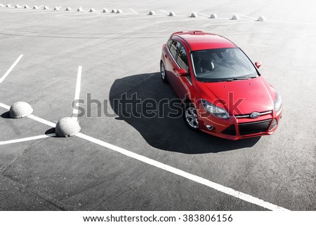 Engels, Russia - September 21, 2014: Red car Ford Focus 3 Sport stay on asphalt parking at daytime
