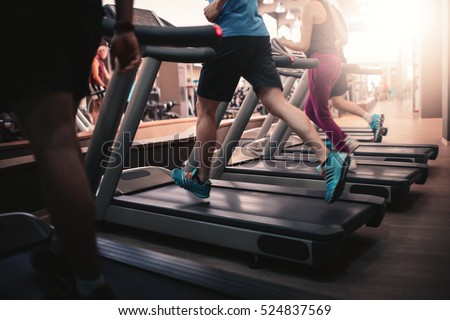 People running in machine treadmill at fitness gym club