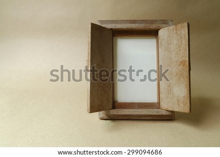 Vintage photo frame on wooden table over grunge background and space for text copy ,Still life style