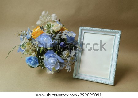 Vintage photo frame on wooden table over grunge background Still life style