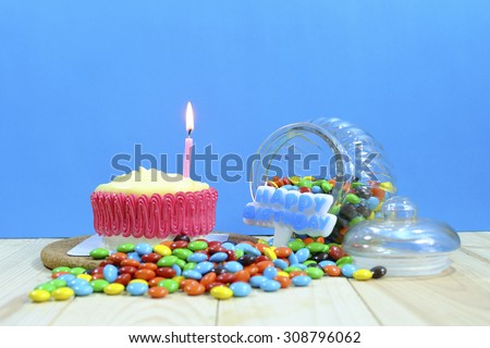 Birthday cake decorated with candles on blue background