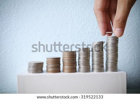 Business idea concept , Hand put coin stacking to money