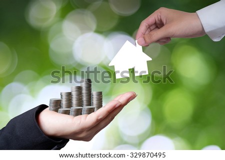 Hand hold money to change the house on green background , business idea and finance concept