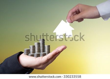 Hand hold money to change the house on light dark background , business idea and finance concept