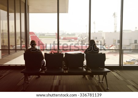 man and woman at Airport waiting for departure , color filter image , business travel airport