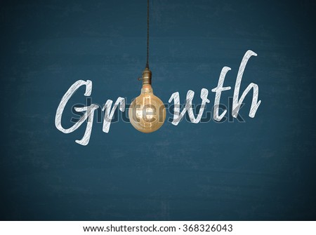 Light bulbs with GROWTH text on blue chalk board , business concept , business idea
