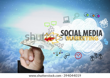 businessman hand holding dollar plane with SOCIAL MEDIA MARKETING text ,business idea , business concept