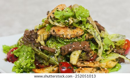 Meat salad with crackers and salad leaves