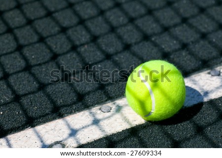 tennis court with ball and net shadow