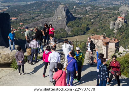 METEORA, GREECE- OCTOBER, 12, 2014: Asian tourists take pictures of Meteora rocks overlooking Kalambaka and the monasteries. Thousands of tourists from all over the world visit the Meteora  every year