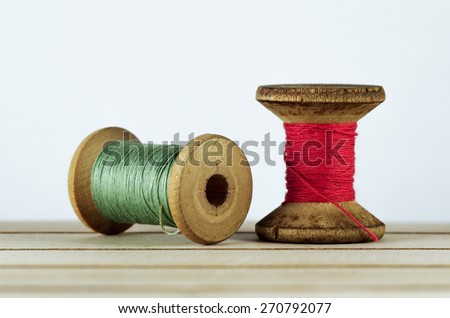 Old spool of thread closeup. Tailor\'s work table. textile or fine cloth making.