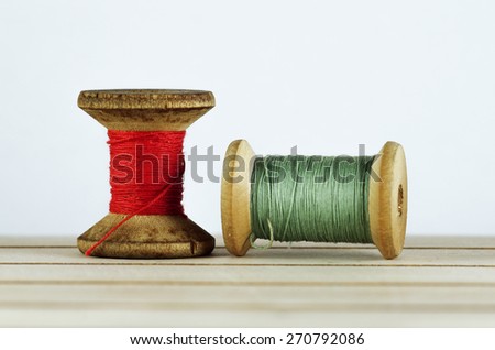 Old spool of thread closeup. Tailor's work table. textile or fine cloth making.