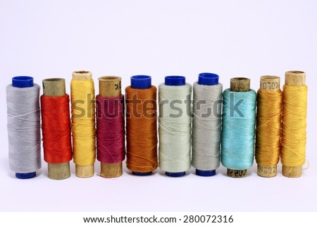 Old spool of thread closeup. Tailor\'s work table, textile or fine cloth making