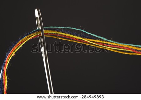 colorful threads in a needle