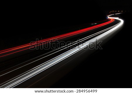 Car light trails,  of traffic on the move at street, urban landscape. Art image, photo taken using exposure