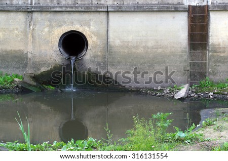 Water pollution in river. Dirty water stems from the pipe polluting the river. Industry not treat water before drain.